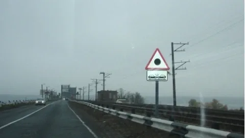 Traffic rules lessons: what does a red triangle with a black dot inside mean