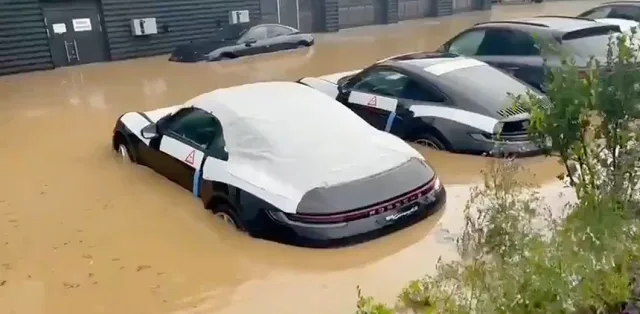 A video of a dozen flooded new Porsches has appeared online