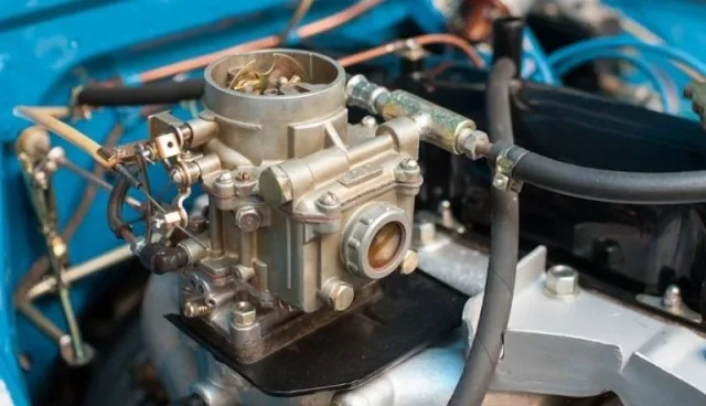 Why does gasoline spray from the carburetor into the air filter?