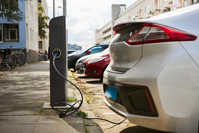 ey-silver-electric-car-at-charging-station.jpg